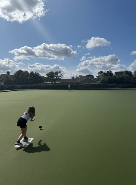 child playing bowls