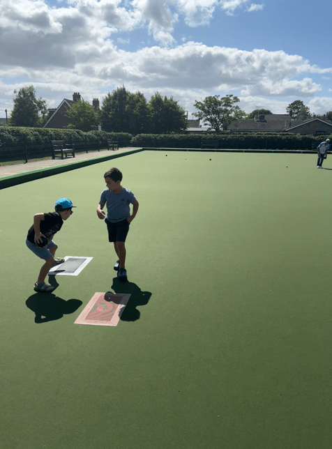 2 children playing bowls