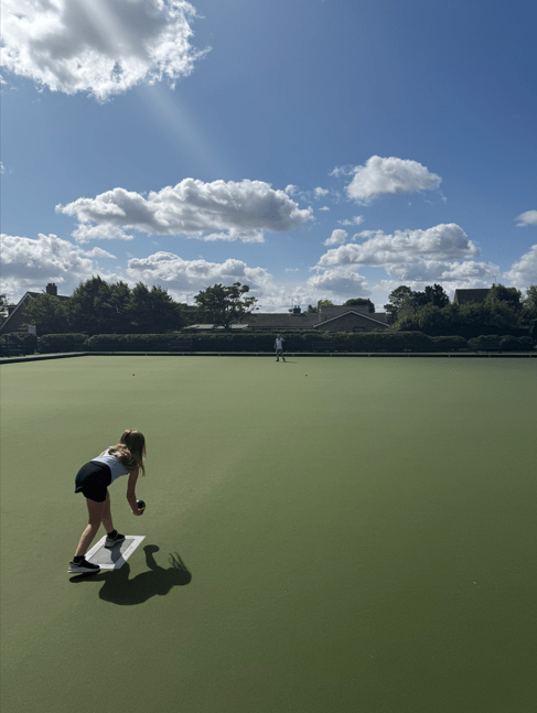 child playing bowls